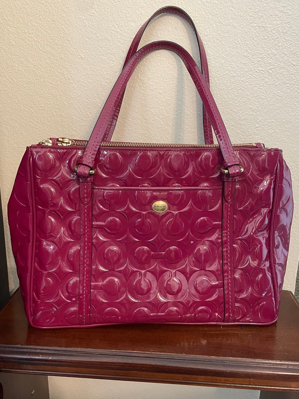 Coach Peyton Op Art embossed patent leather bag in the "Passion Berry" color